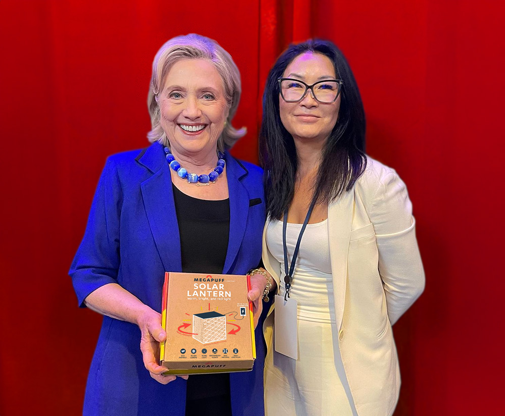 Hillary Clinton holding MegaPuff package with Alice Min Soo Chun.